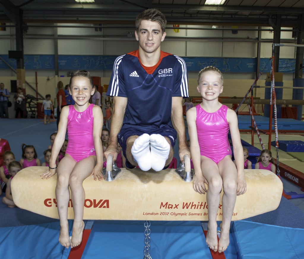 Max Whitlock with seven-year-old gymnasts Caitlin Garbutt, left, and Eve Andrews, right