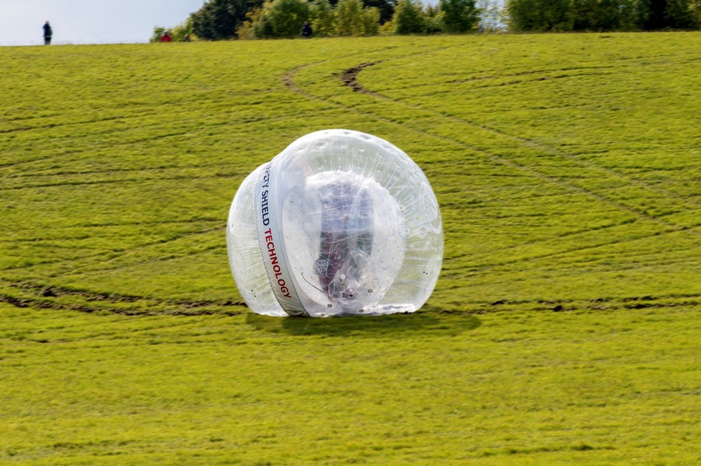 The Nissan Note rolls bonnet-over-boot down the hill, safely protected in the Zorb