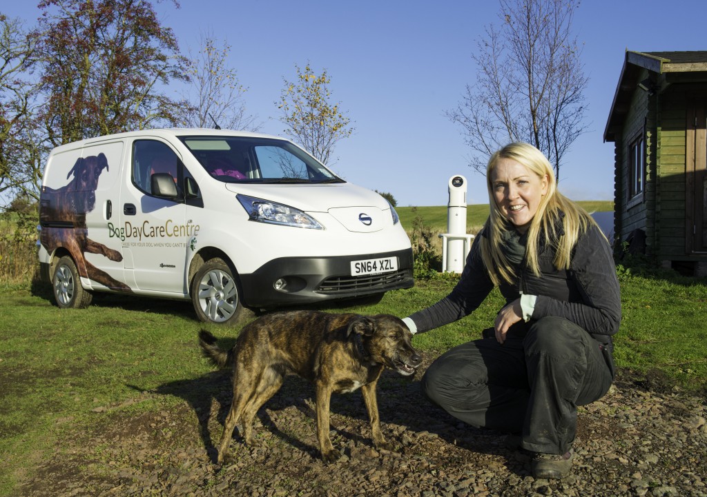 Gillian Black of the Dog Day Care Centre in Gorebridge with cross terrier Pebble who features on the side of the business’s new Nissan e-NV200 van.