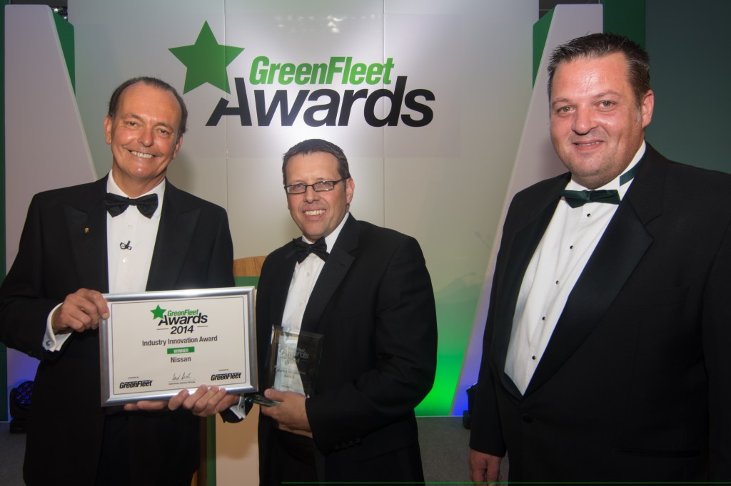 Greenfleet Awards host Quentin Wilson (left) presents Barry Beeston, Nissan Motor GB Corporate Sales Director, with the award for Industry Innovation while Colin Boyton, Sales and Marketing Manager at Greenfleet Events looks on.