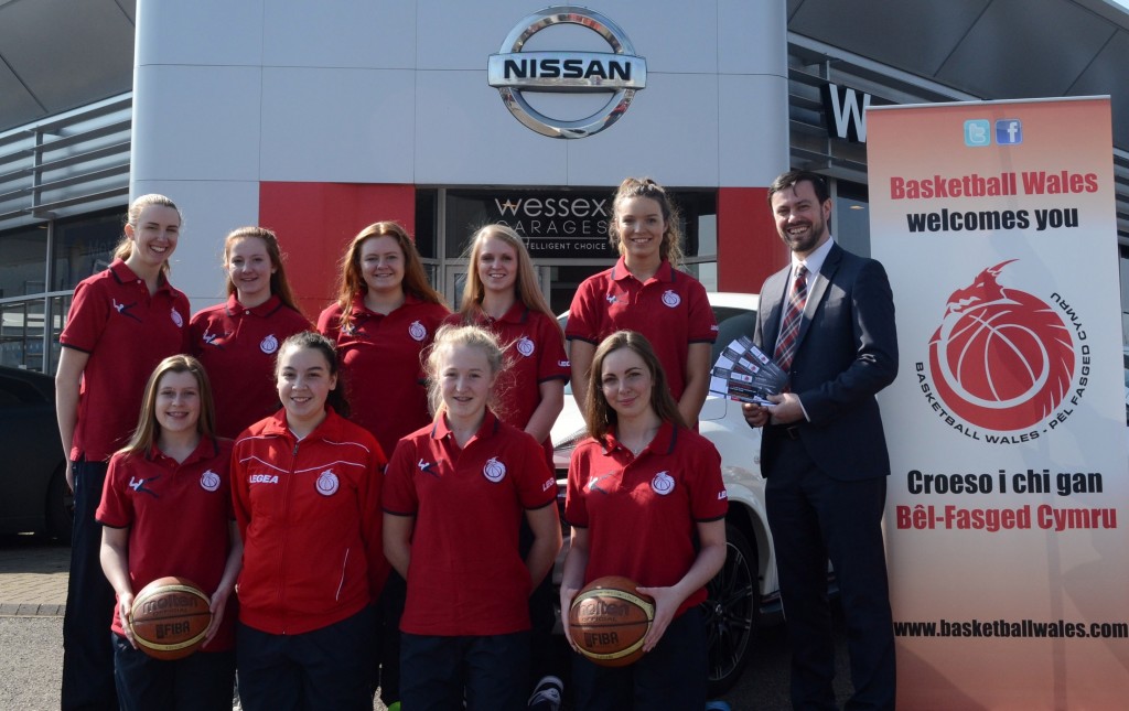 Gareth Howells, General Manager at Wessex Garages, with girls from the basketball teams