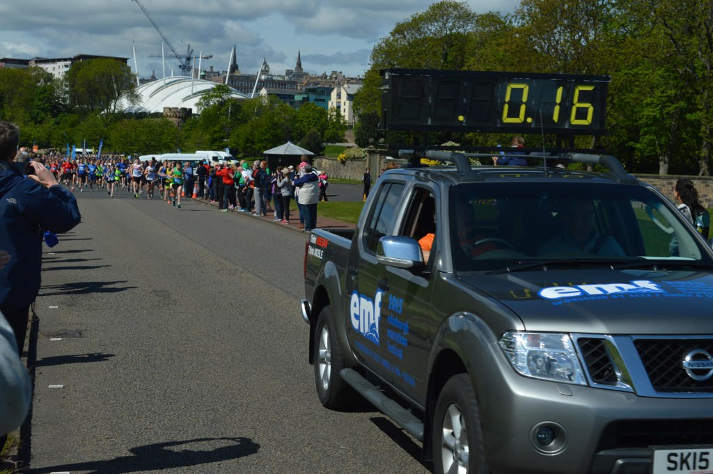 The Nissan Navara clock car supplied by Alex F Noble & Son leading the way at the start of the Edinburgh Marathon Festival 2015.