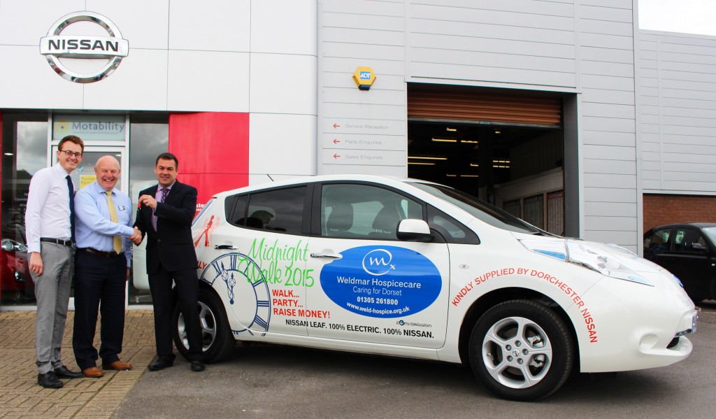 Matt Smith, Community and Events Fundraising Manager for Weldmar Hospicecare, Jon Panton, Business Fundraising Manager for Weldmar, and Tony Jordan, Dealer Principal at Dorchester Nissan, with the branded all-electric Nissan LEAF
