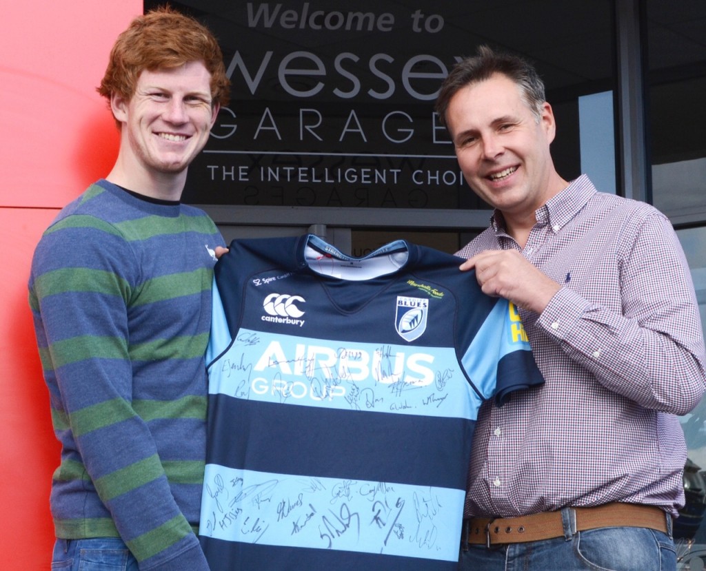 Rhys Patchell, who plays Fly Half for the Cardiff Blues, presents the jersey to Andrew Miller.