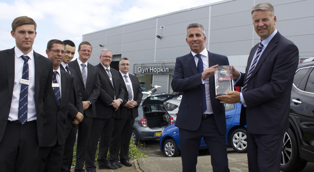 Fraser Cohen, Managing Director of Glyn Hopkin, and his sales team are presented with the Nissan Global Award for the Chelmsford dealership by Dave Murfitt, right, Director of Network Development and Quality at Nissan Motor GB