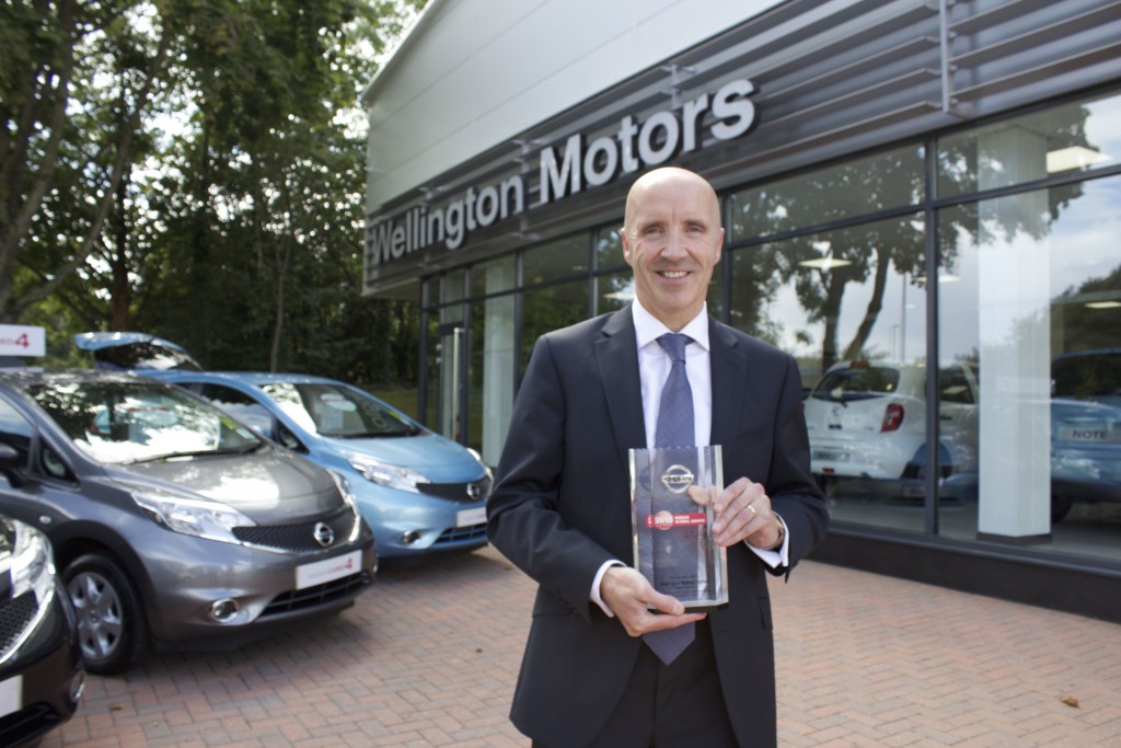 Michael Finn, Dealer Principal of Wellington Nissan, with the Nissan Global Award given to the dealership.