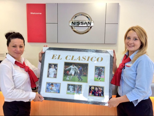 The framed print signed by Ronaldo and Messi which was auctioned off