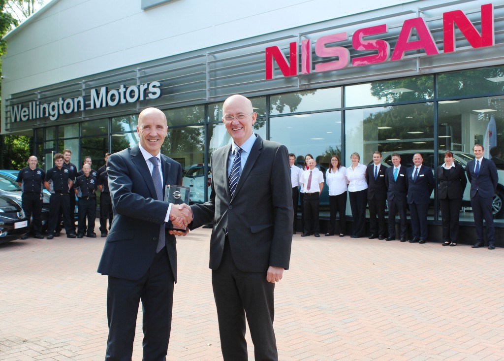 James Wright, Nissan Motor (GB) Managing Director (right) presents Michael Finn, Dealer Principal of Wellington Motors, with the dealership's Nissan Global Award as the team looks on