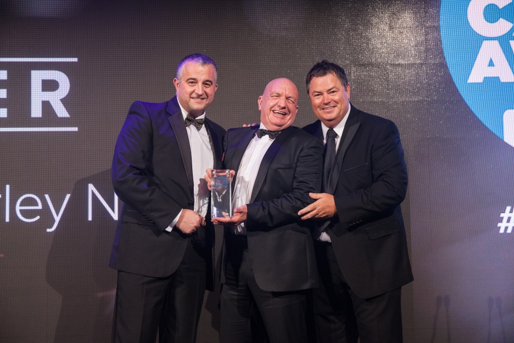 Andy Turner, centre, accepts his award from right, TV personality Mike Brewer, and left, Paul Hibbert, Key Accounts Director at award sponsors, Evolution Funding 