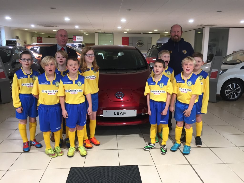 Kevin Abbs, Director of Crayford and Abbs Nissan, with the East Coast Warriors Under 10s and their new sponsored kit