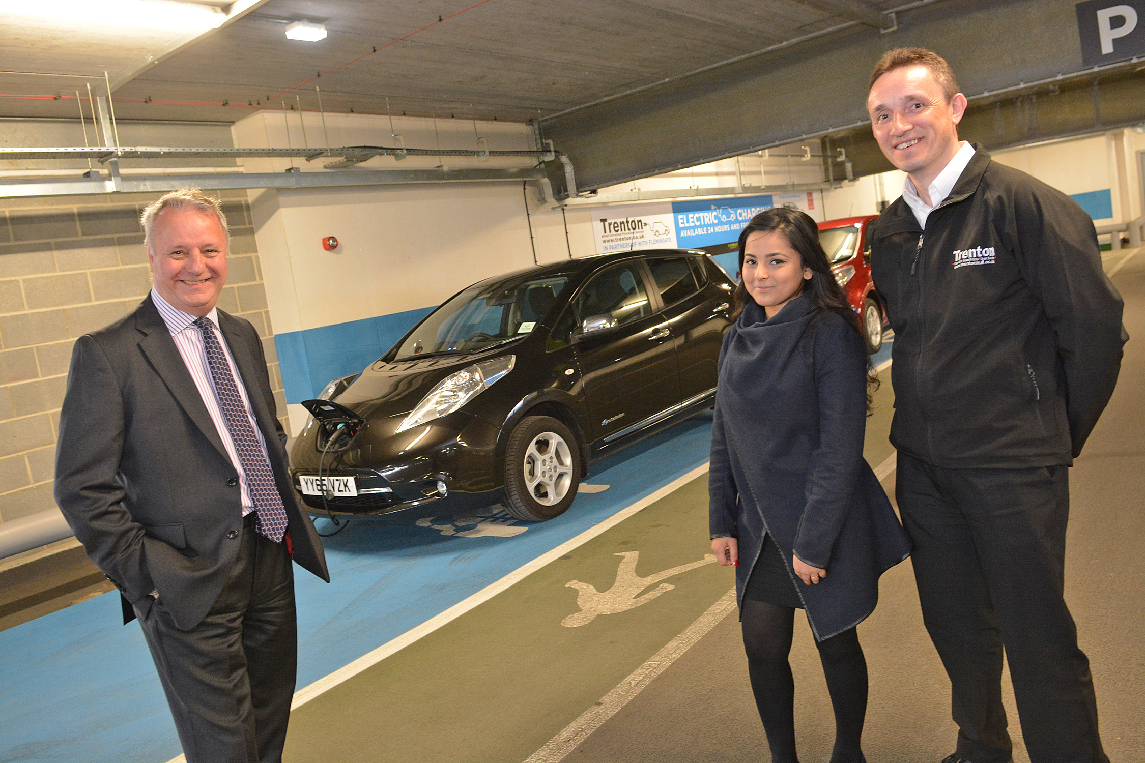  Graham Tait, centre mananger of Flemingate in Beverley, charges up a car from one of the three free the electric charging points in the car park. With Graham are Taslima Tarafdar and Ian Tattersall from Trenton. Pic Simon Kench (Trudi Words)