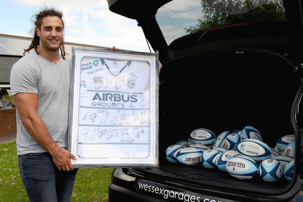 Cardiff Blues player, Josh Navidi, with the signed shirt, which was donated to the raffle in aid of the Layla-Mae Appeal.
