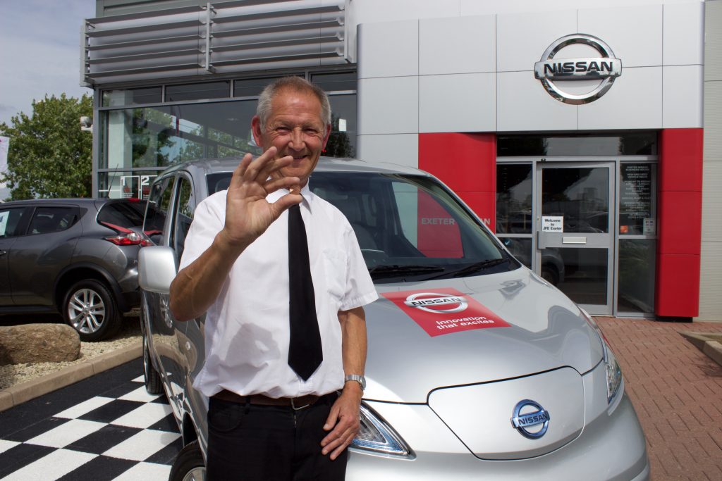 John Cobley, who drives customers around Exeter for the dealership, pictured with the e-NV200 and a penny to show people the cost of electric motoring.