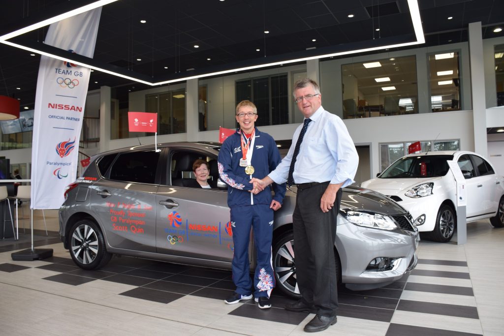 •David Noble, dealer principal at Alex F Noble & Son Nissan presenting the new Nissan Pulsar car to Paralympic swimmer, Scott Quin and Mum, Eileen