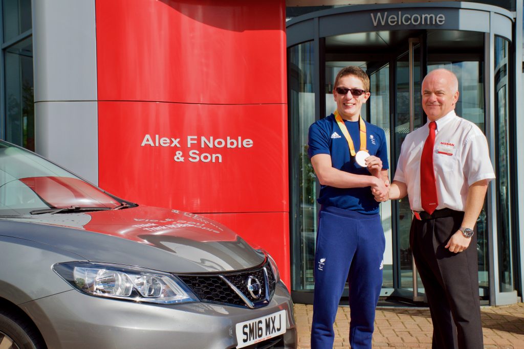 Gordon Campbell, sales manager at Alex F Noble & Son Nissan congratulating Scott Quin on winning his Rio Paralympic silver medal