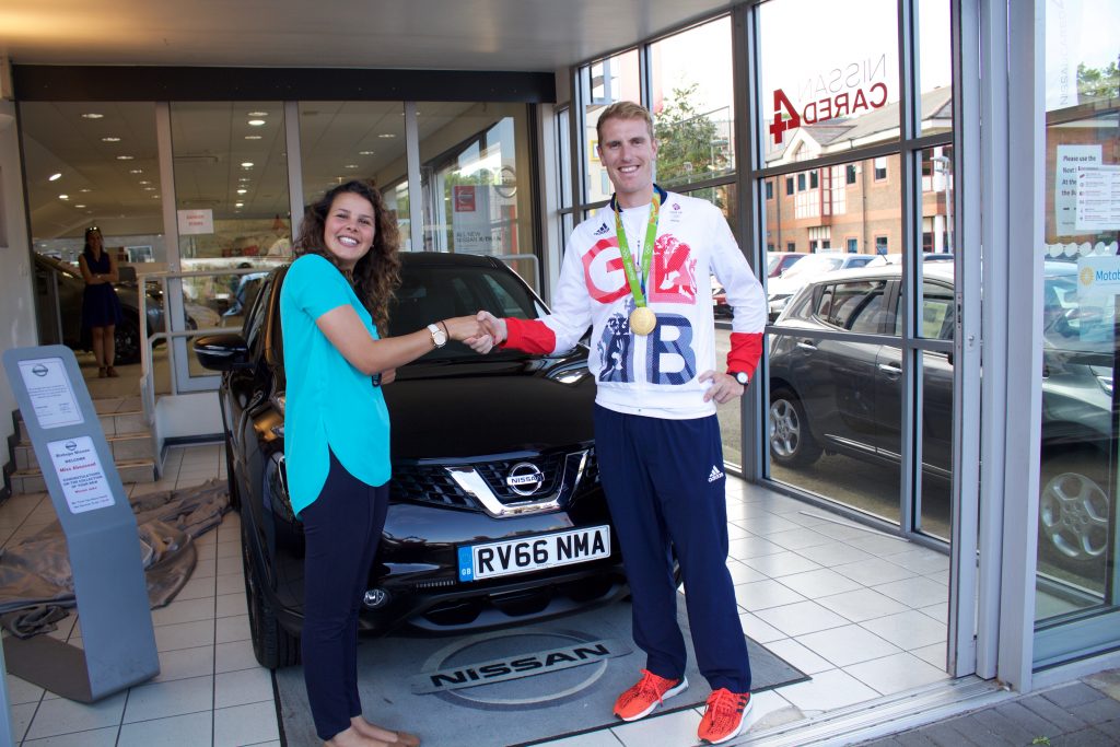 Sonia Aboussad receives the keys to her Nissan Juke from Olympian George Nash