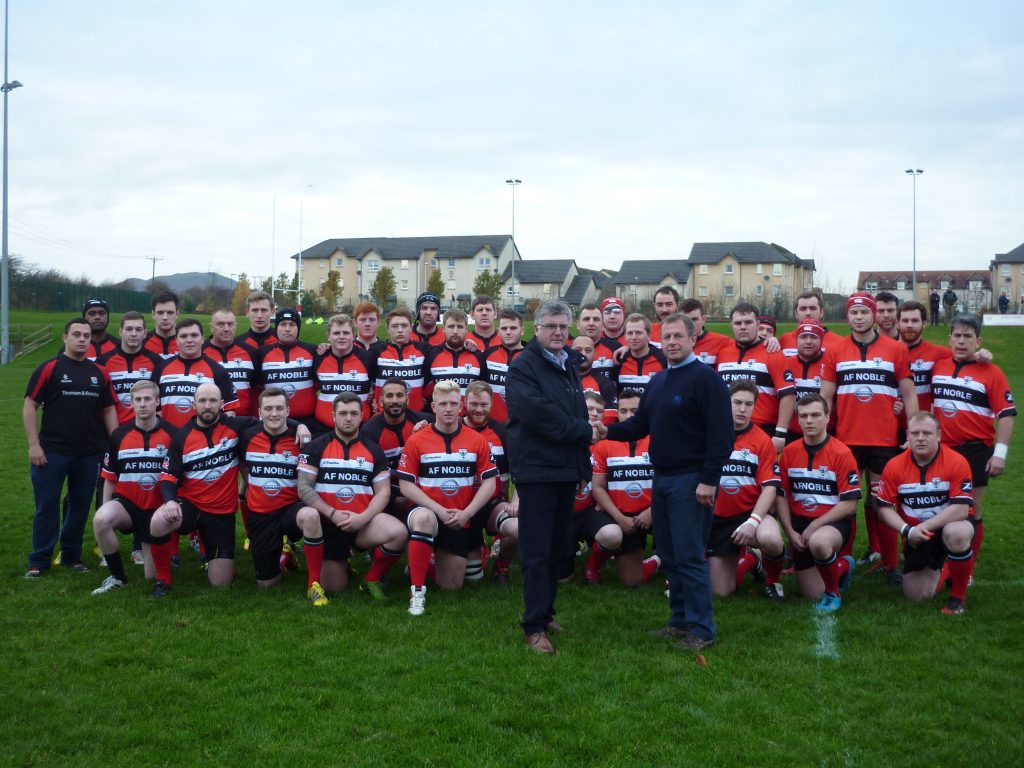 Picture shows (left foreground) David Noble, dealer principal at Alex F Noble and Son Nissan presenting the new team kits to Lasswade RFC president, Ian Barr and club players