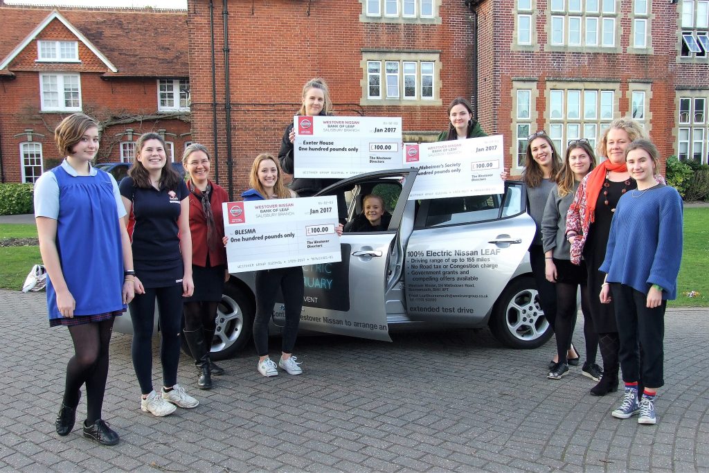 Students from Godolphin School with the Nissan LEAF and cheques for their three chosen charities