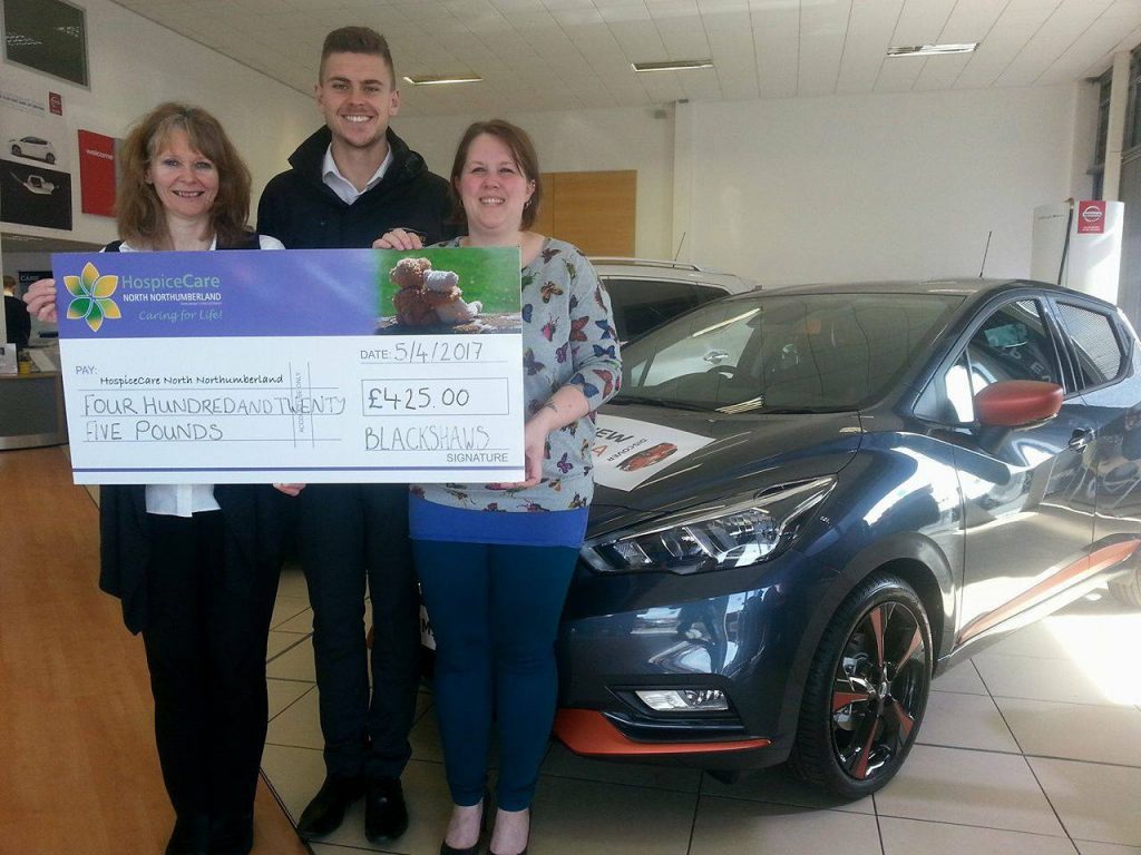 Susan Blackshaw and Ross Straughan from Blackshaws Nissan present a cheque to Emma Arthur from HospiceCare.