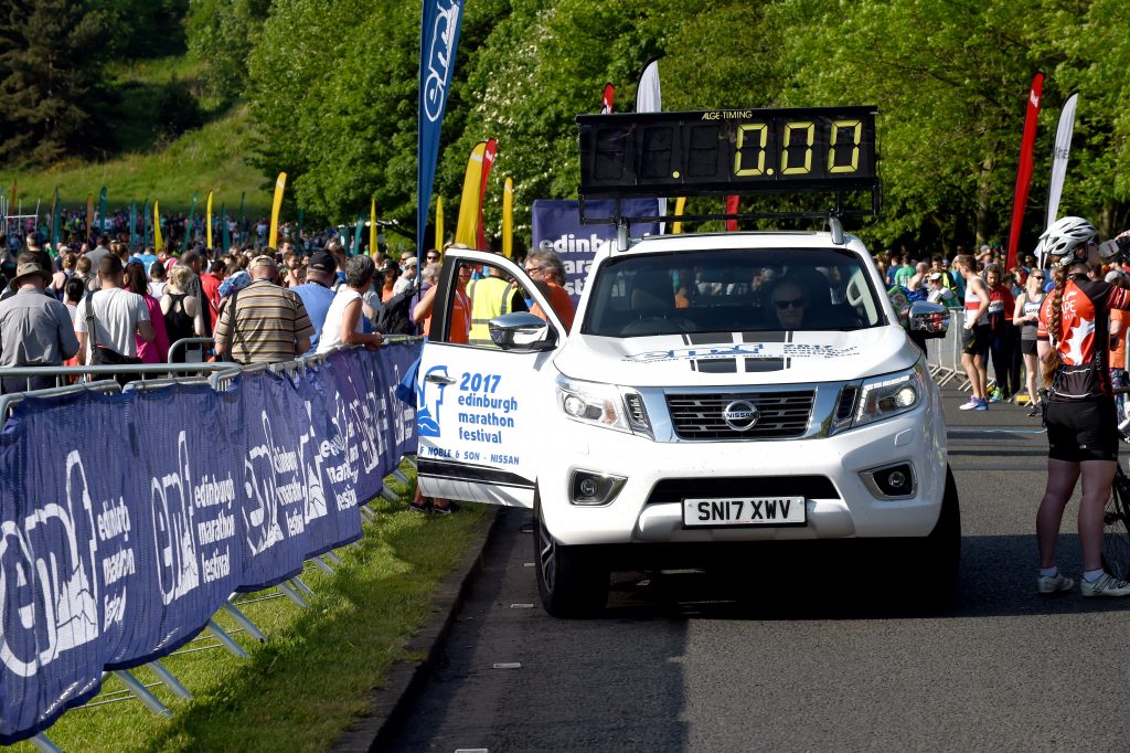 The Alex F Noble & Son Nissan Navara clock car at the start of the Edinburgh Marathon.